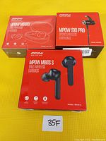 Photo shows three boxed wireless earbud sets from MPOW, including MDots, S10 Pro, and MBits S models.