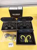 Photo of 3 pairs of true wireless stereo sport earbuds with charging cases, USB cable, and extra ear tips.