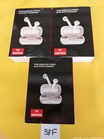 Three boxed sets of true wireless stereo Bluetooth earbuds shown from the front, displaying the earbuds in open charging cases.