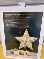 Box image showing product details and features of the Christmas Star Tree Topper in glitter gold with LED lights
