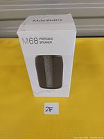 Front view of the original box showing the MusiBaby M68 Portable Speaker image and branding.