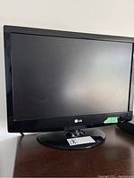 Front view of the 22 inch LG TV showing the screen and pedestal stand with MaxSold tag.