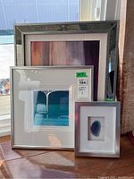 Four framed wall art pieces shown together, including abstract prints, metallic drip painting, and a framed blue agate slice.