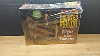 Front side of the Haunted Manor Flight of the Vampire model kit box, showing the product name, branding, and some artwork with a vampire figure.