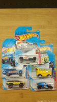Front view of 5 Hot Wheels cars in original packaging showing the lot contents and brand details
