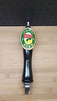 Front view of a black beer draft handle with Lemon Tea Beer logo showing oval emblem with lemons and text.