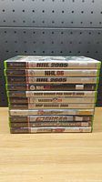 Stack of 11 original Xbox sports games showing titles and cases in good condition.
