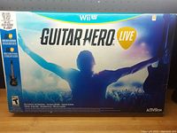 Box showing the Wii U Guitar Hero Live game with front cover art and branding.