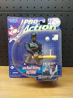 Front view of sealed Starting Lineup Ken Griffey Jr. Pro Action figure in Mariners uniform holding yellow bat with original packaging.