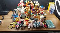 Full view of entire vintage clown collection including figurines and dolls arranged on wooden surface