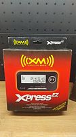 Front view of the XM Satellite Radio Xpress EZ box showing the packaging and branding.