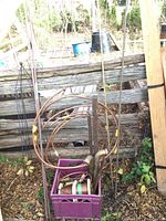 Photo showing copper tubing coils, metal rods, and a crate with fittings
