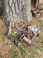 Overview photo of all parts together on leaves near tree, showing slide-in slide hitches, drop hitches, Singer parts, jack.
