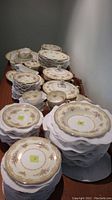 Overall view of stacked plates, cups and serving pieces on table