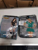 Packaged Detective Celia Fate and nurse costumes displayed side by side on a table