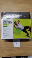 Front of the box showing the product name, image of a male exercising on the green stability ball, and key benefits.