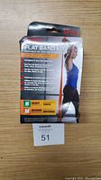 Front of the SPRI Flat Band Kit packaging showing product description and usage information. Packaging has distressed areas but product is new.