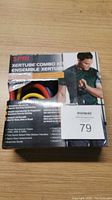 Photo showing front of SPRI Xertube Combo Kit box with partial visibility of resistance tubes inside the carton.