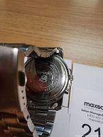 Back of the Timex Ironman Triathlon watch showing stainless steel back with engraved logo, text, and bracelet end.