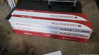 Stack of 6 boxes of Mannington Adura flooring sealed in original packaging with red and white branding.