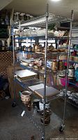 Full side view of the shelving unit loaded with various items showing general structure and condition.
