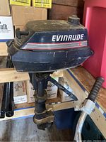 Side view of the Evinrude outboard motor showing overall condition and branding.