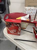 Red decorative tray, leaf-shaped ornament box, and some fabric items