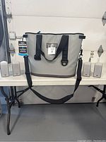 Yeti cooler centered on table with two pairs of JVC speakers on either side