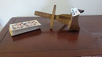 Top angled view of wooden stereoscope and stack of stereoscopic slides, showing the slides' printed images