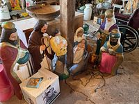 Overview of all figurines and animals arranged around a post in barn interior