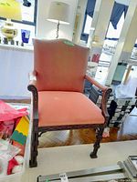 Full front view of the wood frame side chair with upholstered coral seat and back, shagreen leather arm and back sides, showing chair design and condition with some visible wear marks on fabric.