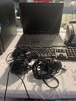 Dell Vostro 1710 laptop with keyboard, mouse and charged cables with power adapters