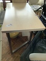 Top and side view of computer table showing wood grain Formica surface and metal base legs.