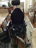 Full view of wheelchair showing seat, high-back, headrest, armrests and front casters