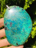 Front view of the large turquoise boulder pendant showing vibrant blue and green hues with black matrix.