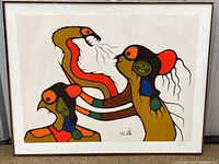 Framed print featuring three indigenous-style figures in bold earth tone and bright colors with signature at bottom right.