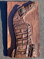 Full front view of cedar eagle plaque on asphalt background