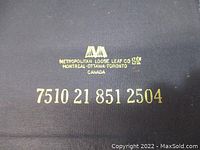 Close-up image of the text in gold on the binder cover identifying manufacturer and a numeric code.