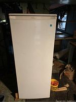 Front view of Danby upright freezer showing white exterior door with handle on top right corner.