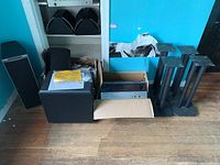 Group shot of two tower speakers, center speaker, bookshelf speakers, subwoofer, receiver, speaker stands