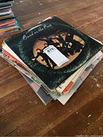 Stack of vinyl records showing the album 'Band on the Run' by Paul McCartney and Wings on top.