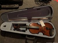 Cremona SV75 violin in open hard-sided case showing violin and bow.
