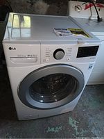 Front view of washer showing door, control knob and overall condition