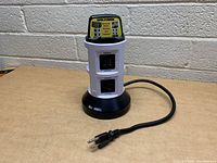 Side view of the Bell + Howell Spin Power power cord extender showing outlets and cord.