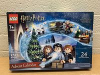 Front view of boxed LEGO Harry Potter Advent Calendar set 76390 featuring the 24 gift mini builds and key characters.
