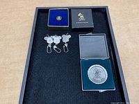 Overview of the Disney Mickey pins and keychains lot with boxed pins and three metal keychains.
