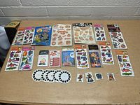 Entire lot laid out showing all stickers, tattoos, toy snapper, and reels