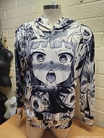Front view of men's hoodie featuring black and white manga-style anime character faces print.