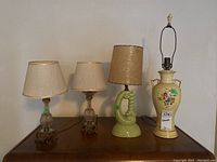 Four table lamps arranged together for overview, showing variety of materials and sizes