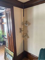 Full view of lamp installed in corner showing overall height and three shades